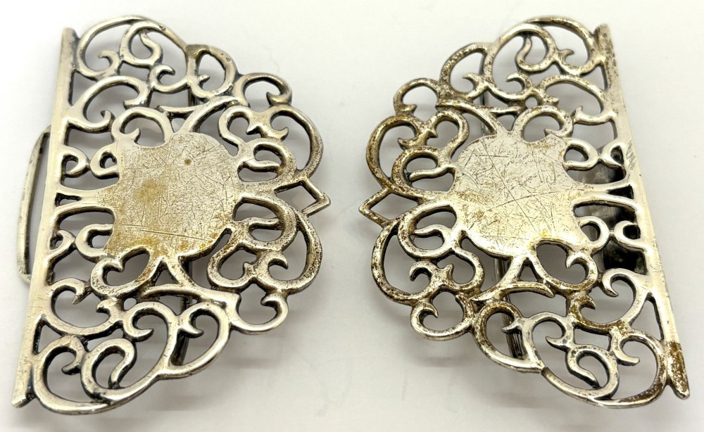 A two-piece pierced silver belt buckle with intricate scrollwork detailing, presented inside its original silk-lined presentation box. View V