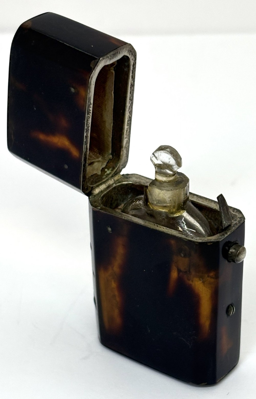 A small Georgian hinged tortoiseshell case shown open beside its matching clear glass scent bottle with a glass stopper. View III