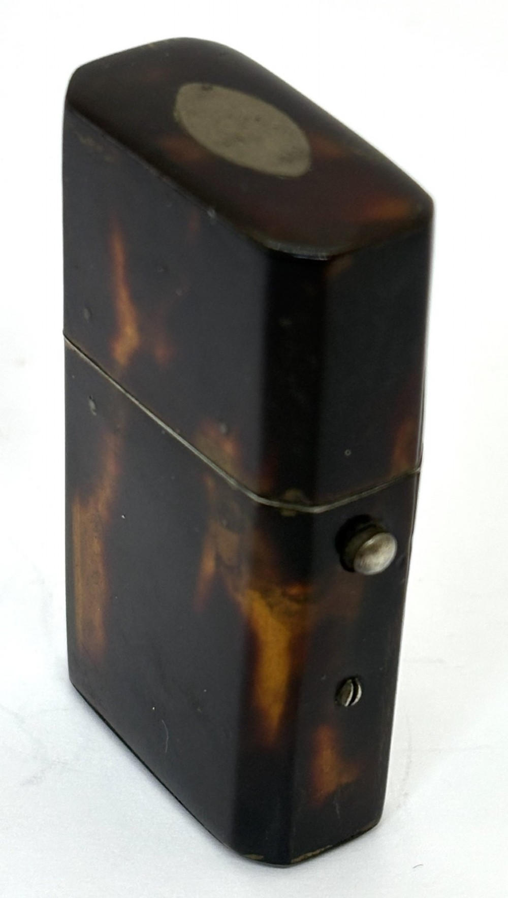 A small Georgian hinged tortoiseshell case shown open beside its matching clear glass scent bottle with a glass stopper. View V