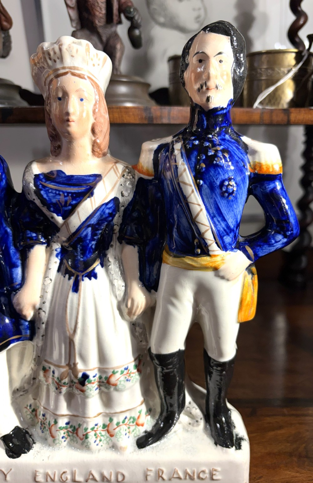 A Victorian Staffordshire earthenware figure group representing Turkey, England, and France, painted in blue, white, and orange enamels. View IV