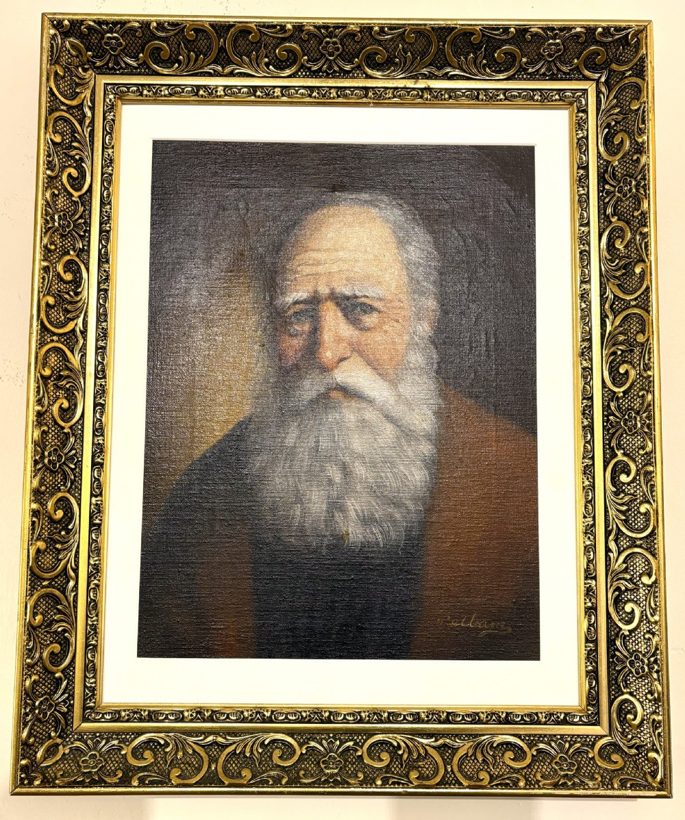 An oil painting on canvas depicting an elderly man with a grey beard, housed in an ornate gold-coloured frame.