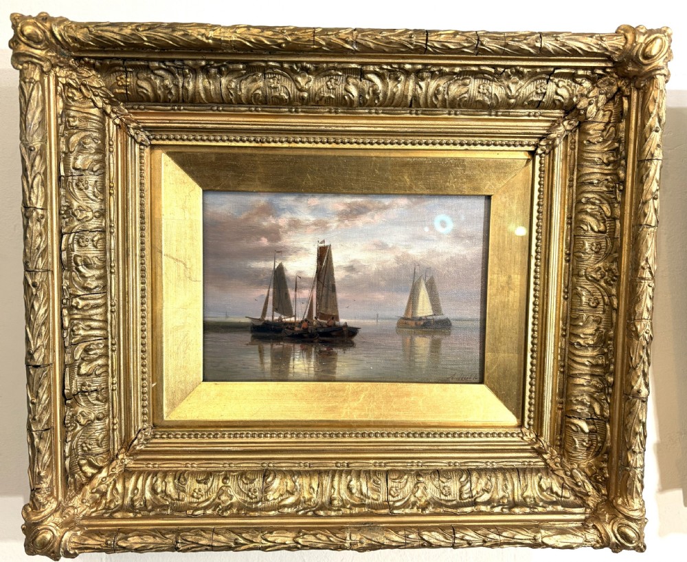 A pair of 19th-century maritime oil paintings depicting sailing ships at sea, housed in elaborate gilded ornate frames. View II