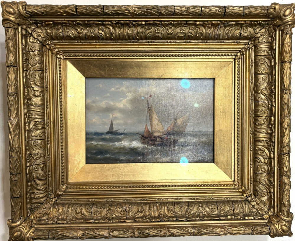 A pair of 19th-century maritime oil paintings depicting sailing ships at sea, housed in elaborate gilded ornate frames. View IV