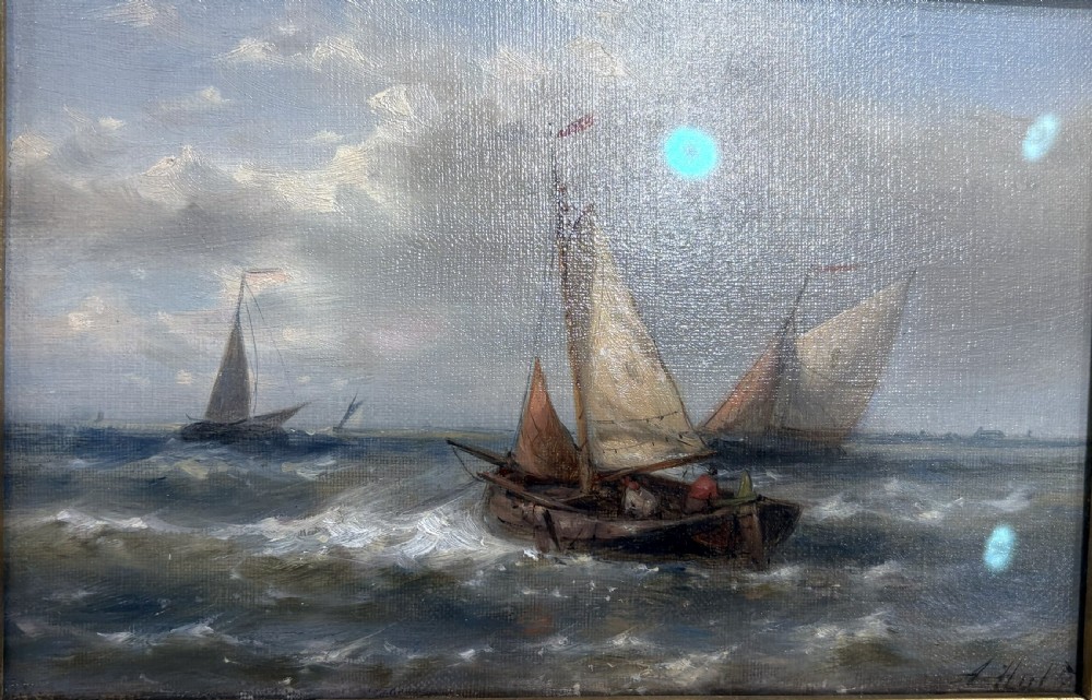 A pair of 19th-century maritime oil paintings depicting sailing ships at sea, housed in elaborate gilded ornate frames. View V