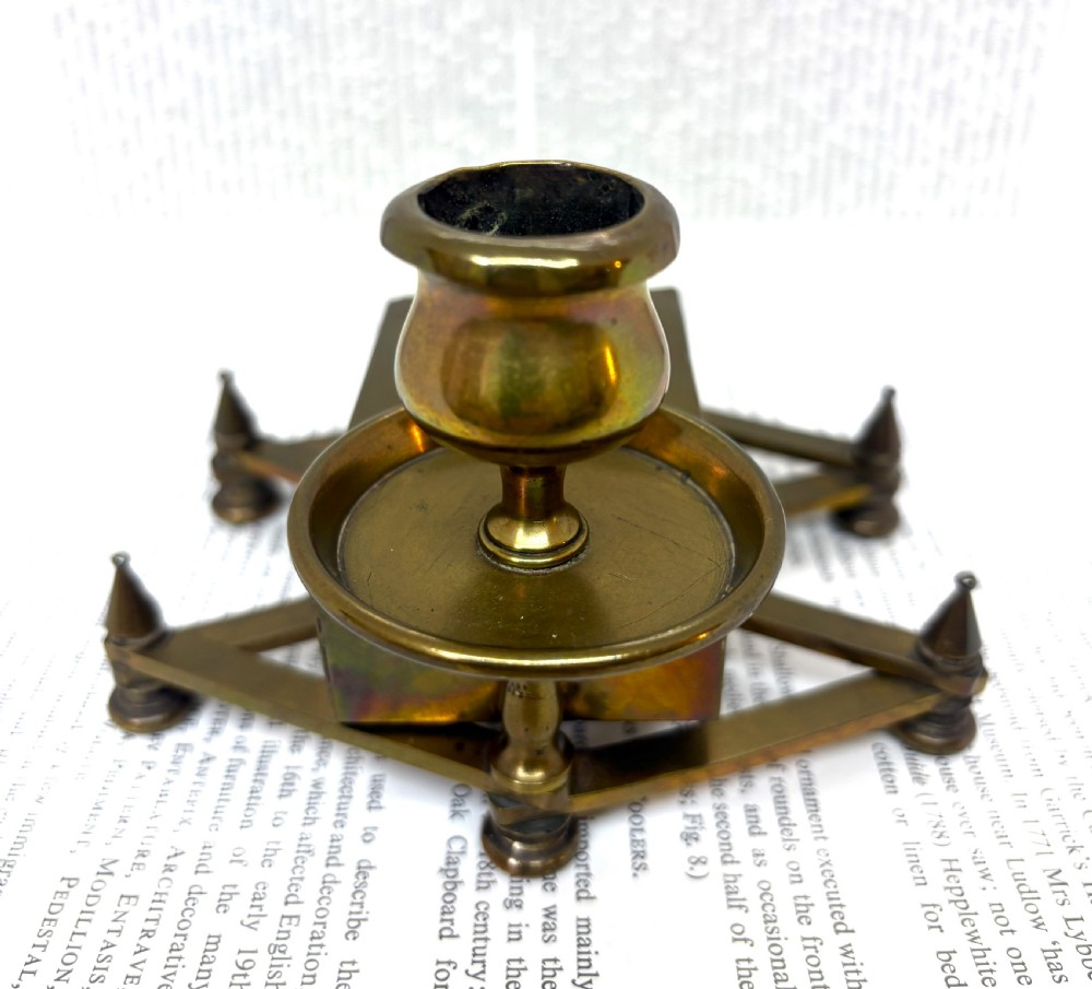 A Victorian brass chamberstick featuring an extending scissor mechanism attached to a rectangular vesta match box base. View III