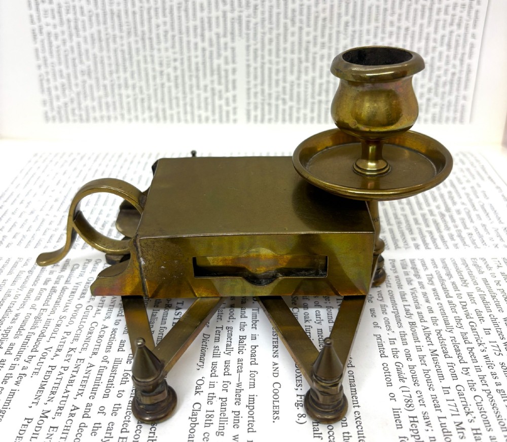 A Victorian brass chamberstick featuring an extending scissor mechanism attached to a rectangular vesta match box base. View IV