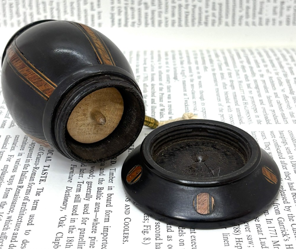 A turned dark lignum vitae wooden string barrel featuring inlaid geometric wood bands, a top turned finial, and a brass dispensing nozzle. View IV