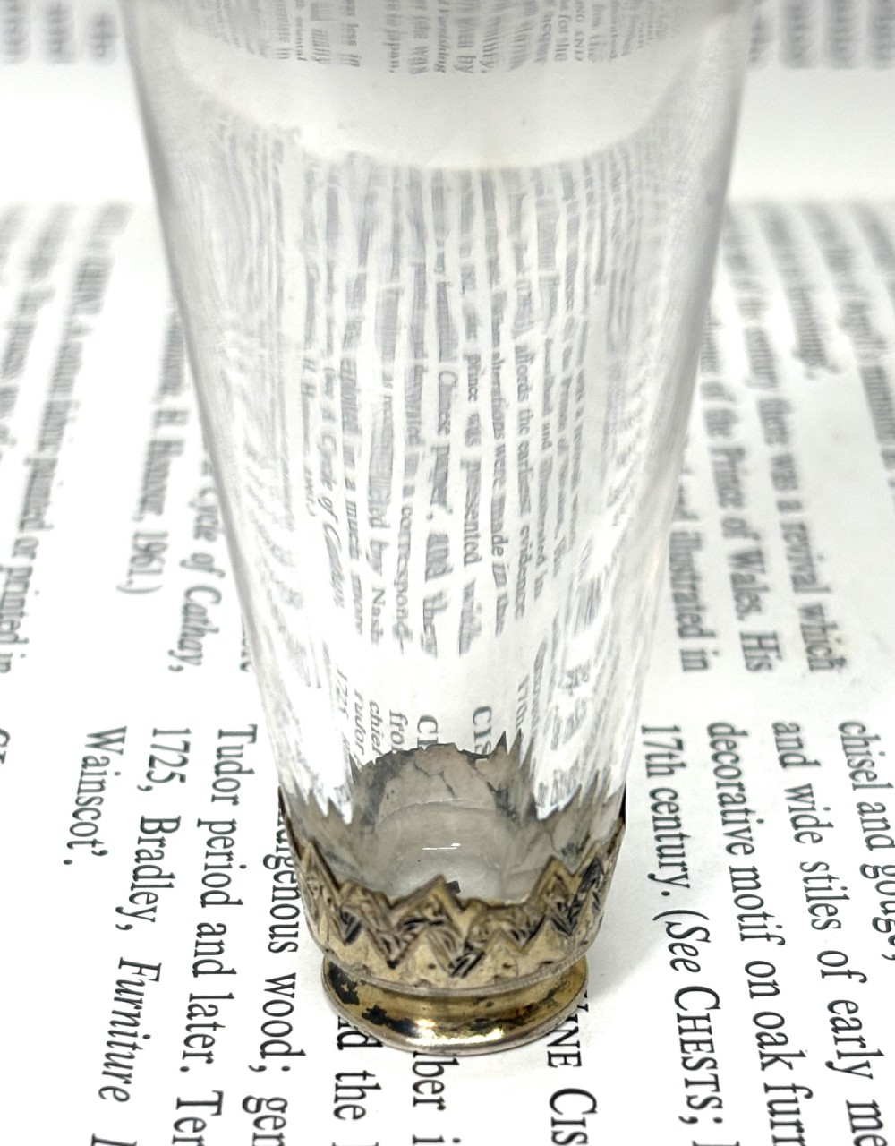 An early nineteenth-century clear fluted glass scent bottle with detailed silver-gilt engraved mounts on the top and base. View III