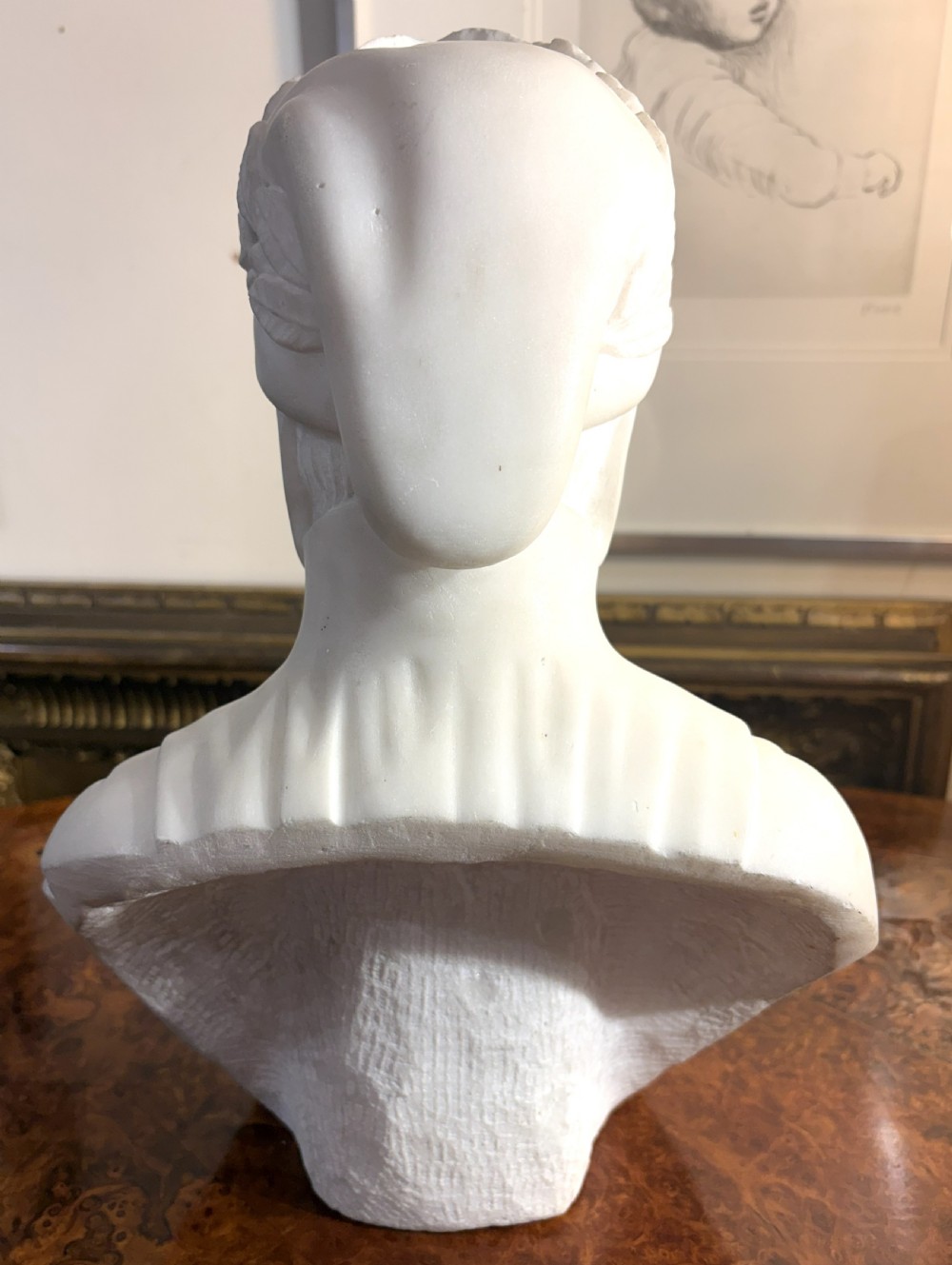 A carved white marble portrait bust depicting Dante Alighieri wearing a laurel wreath and traditional coif. View IV