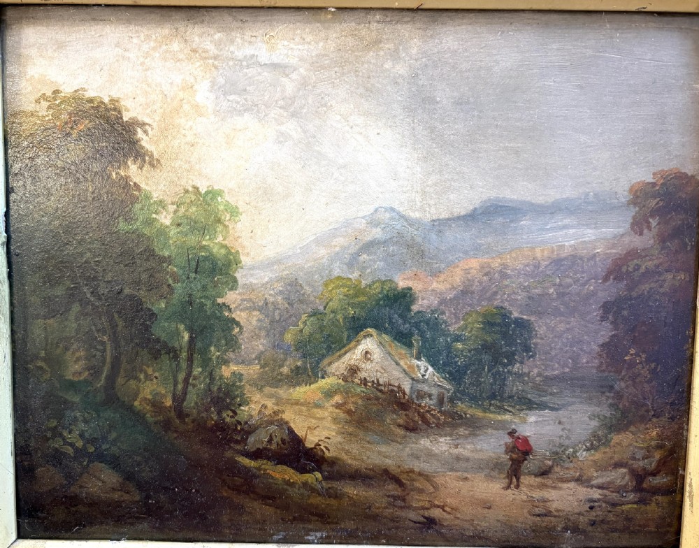 An antique oil painting on board depicting a rural figure walking near a cottage amidst trees and distant mountains, set within a carved gold gilt frame. View II