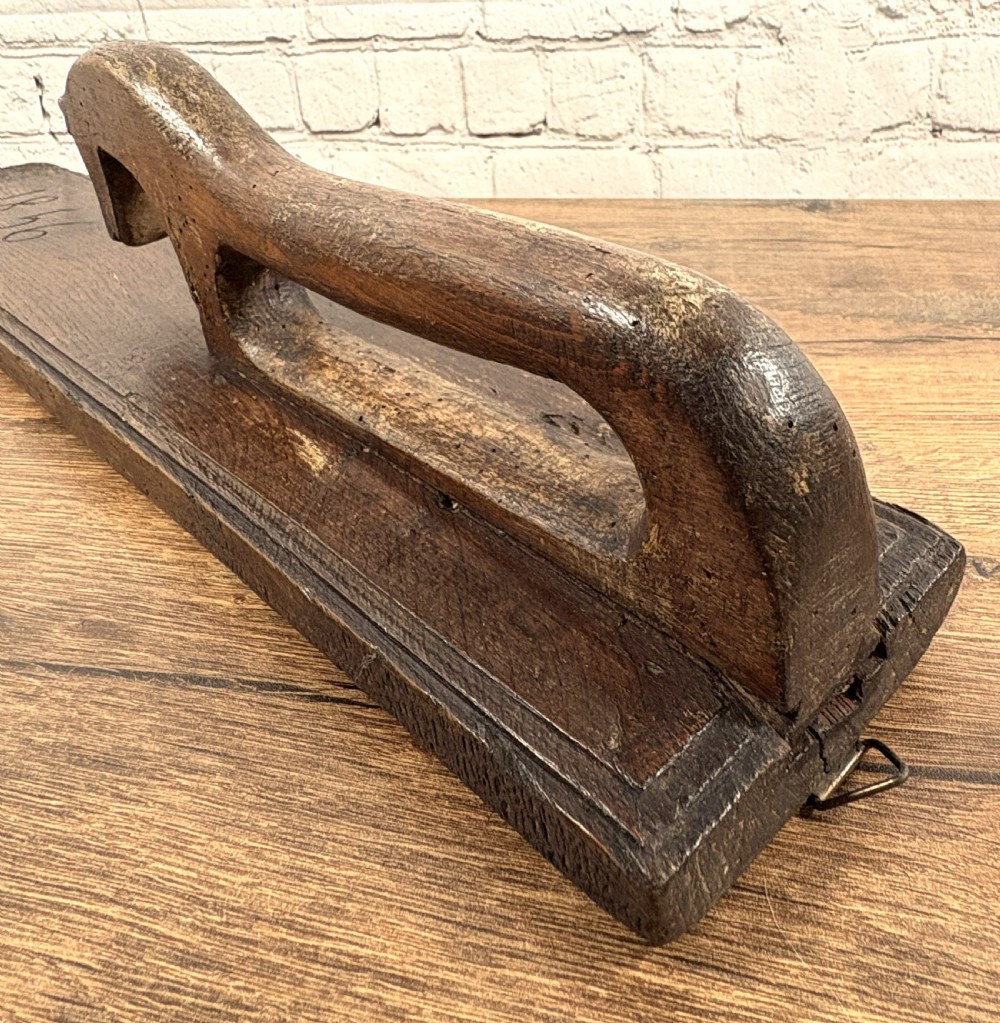 A dark carved wooden Norwegian mangle board featuring a handle shaped like a stylised horse and the carved date 1856. View V