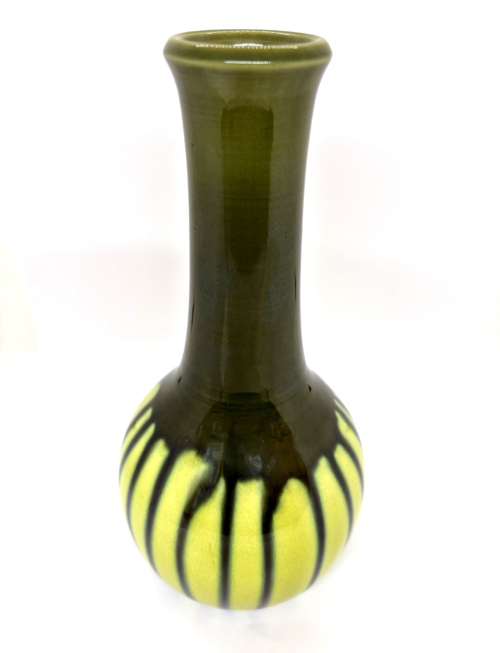 An antique ceramic vase with an elongated neck and bulbous base featuring a dark olive green drip glaze running down over a chartreuse yellow ground.