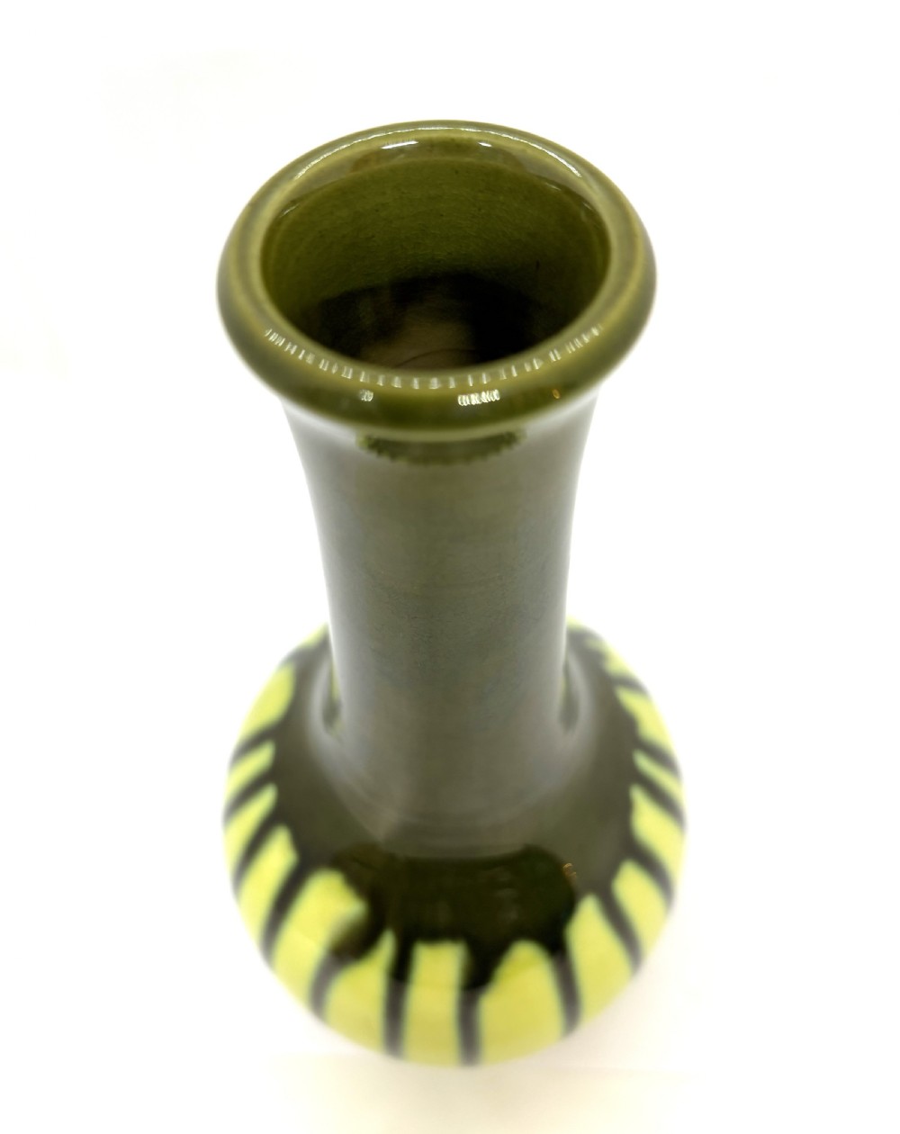 An antique ceramic vase with an elongated neck and bulbous base featuring a dark olive green drip glaze running down over a chartreuse yellow ground. View II
