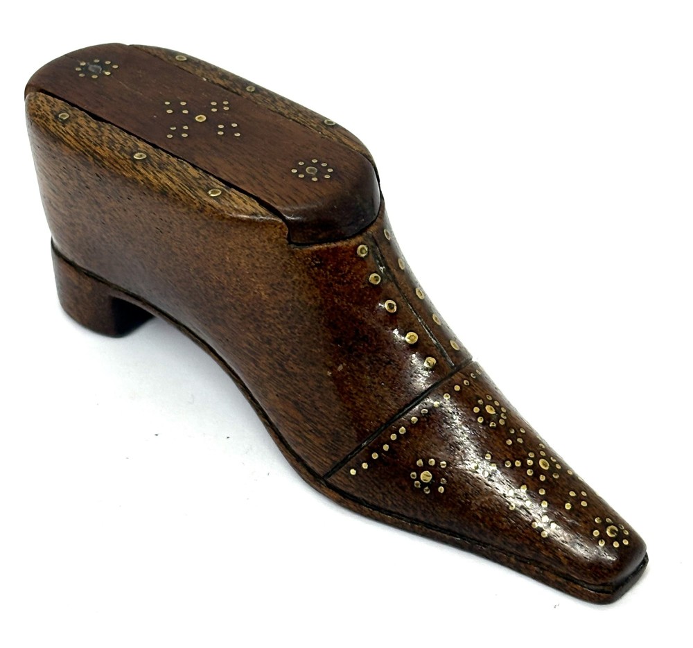 A carved dark wood Georgian snuff box shaped like a shoe with brass pinwork inlay and a sliding top lid. View II