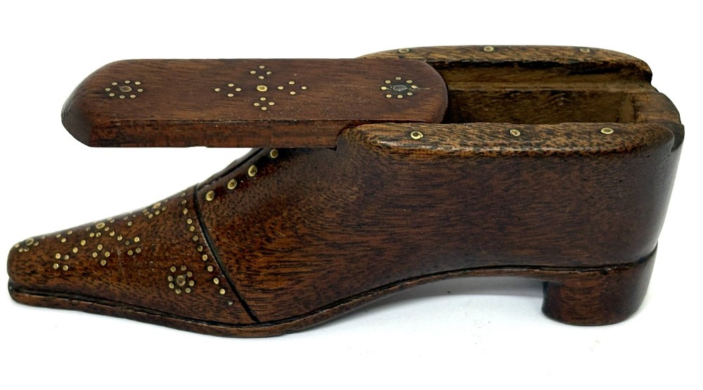 A carved dark wood Georgian snuff box shaped like a shoe with brass pinwork inlay and a sliding top lid. View III