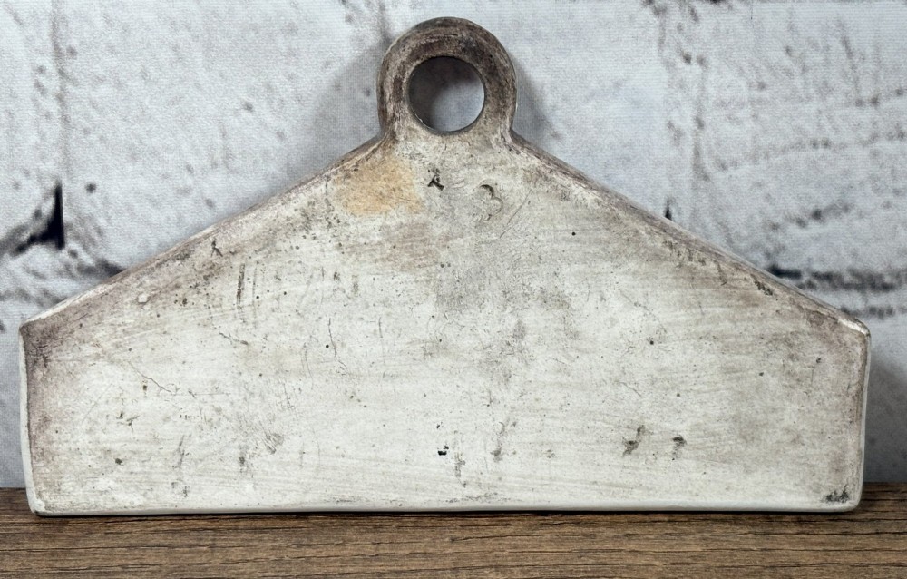 A 19th-century cream-glazed earthenware wine bin label featuring a top hanging hole and the word SHERRY printed in black serif lettering. View II