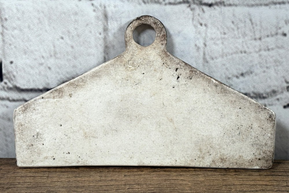 A 19th-century off-white glazed pottery wine bin label featuring the word SHERRY in black serif lettering with a top hanging hole. View II
