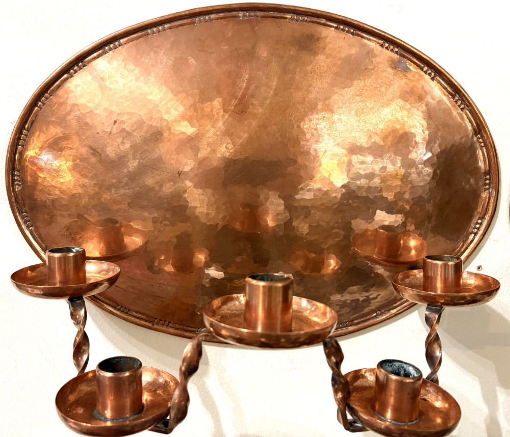 A pair of hand-hammered oval copper wall sconces featuring beaded outer borders and five curved, twisted candle branches. View II