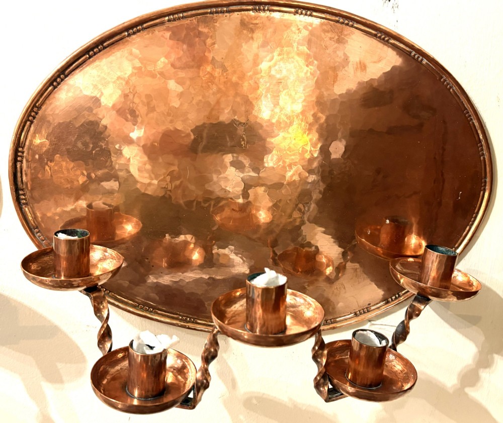 A pair of hand-hammered oval copper wall sconces featuring beaded outer borders and five curved, twisted candle branches. View III