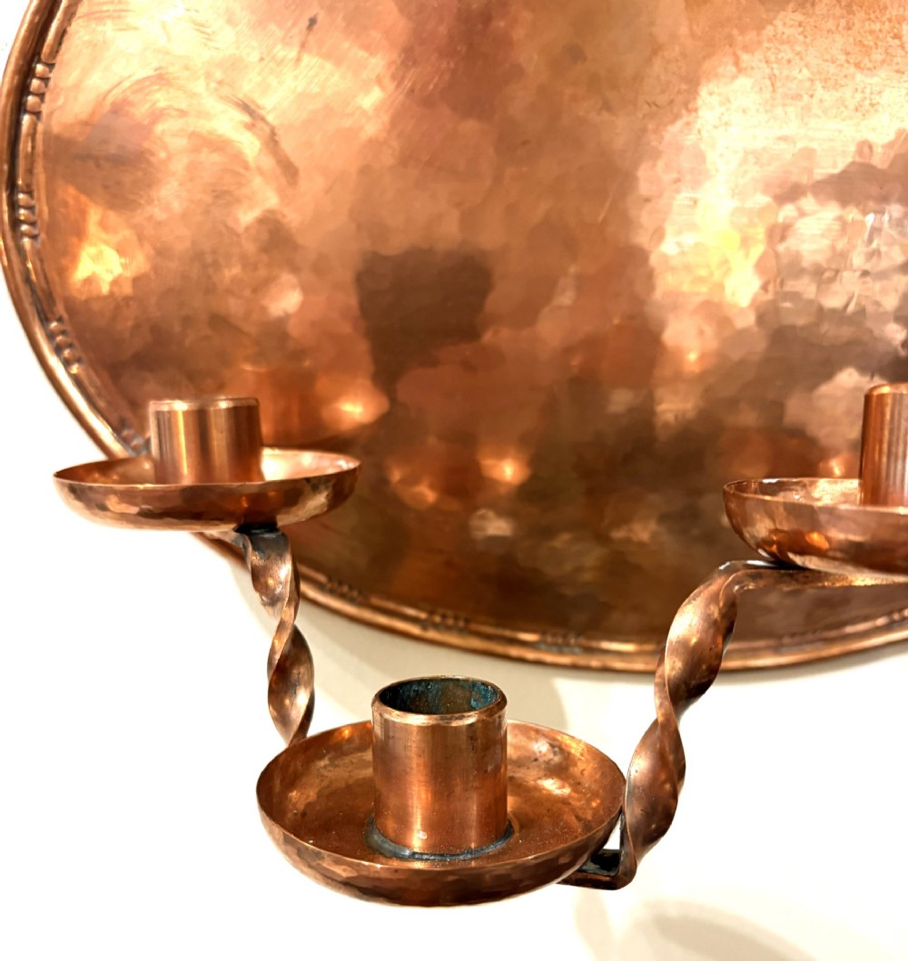 A pair of hand-hammered oval copper wall sconces featuring beaded outer borders and five curved, twisted candle branches. View IV