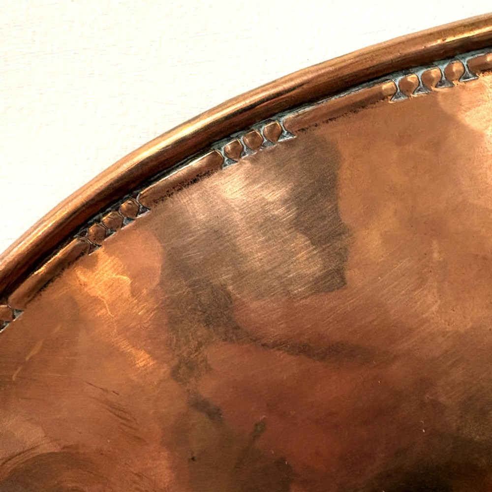 A pair of hand-hammered oval copper wall sconces featuring beaded outer borders and five curved, twisted candle branches. View VI