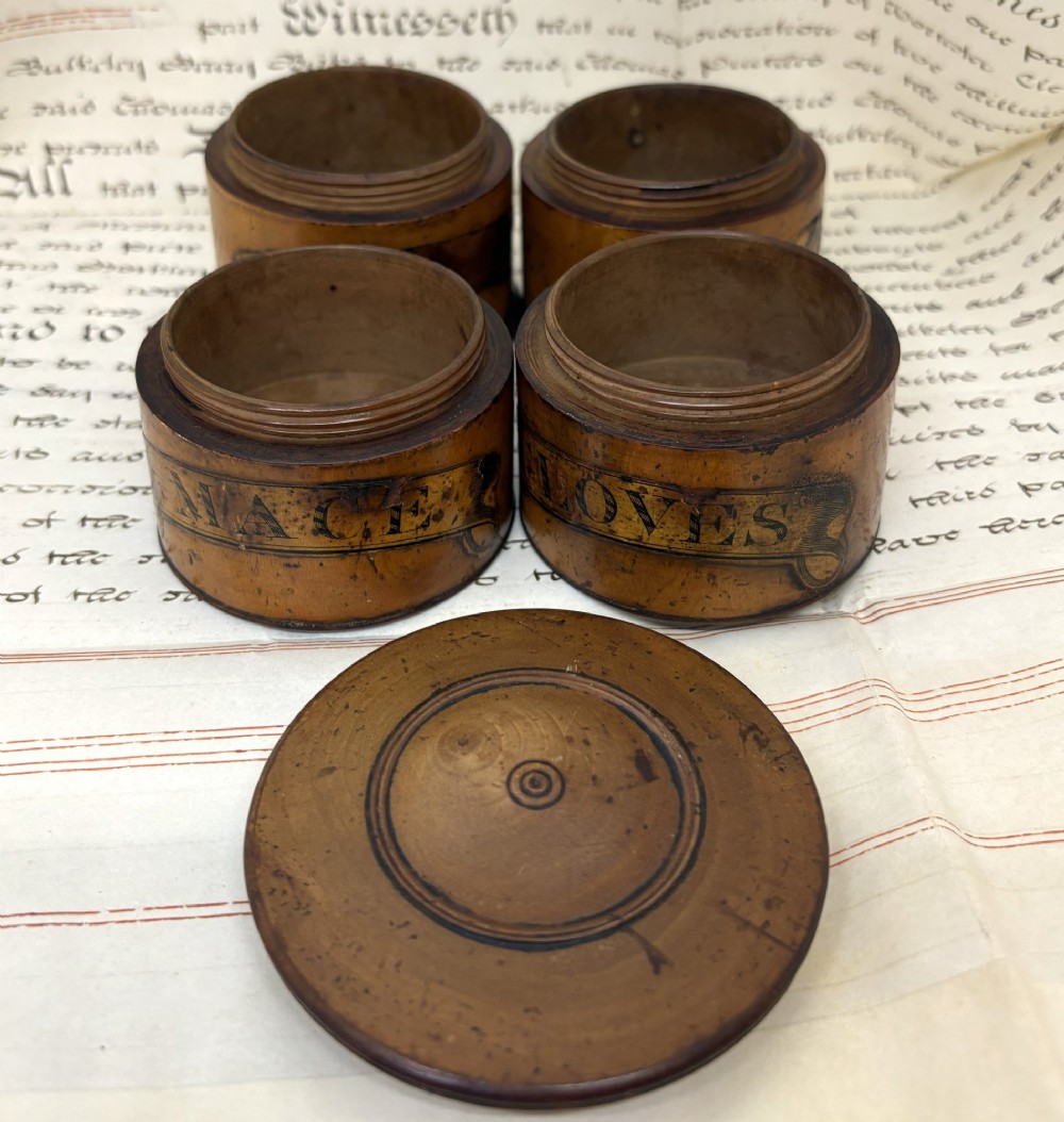 A cylindrical Georgian turned wood spice tower featuring stacked compartments with printed black lettering including Cloves and Mace. View II