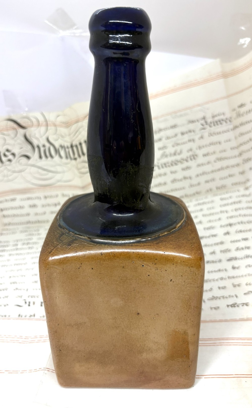 An antique Royal Doulton square stoneware bottle vase featuring a tan base and a glossy deep cobalt blue neck. View II