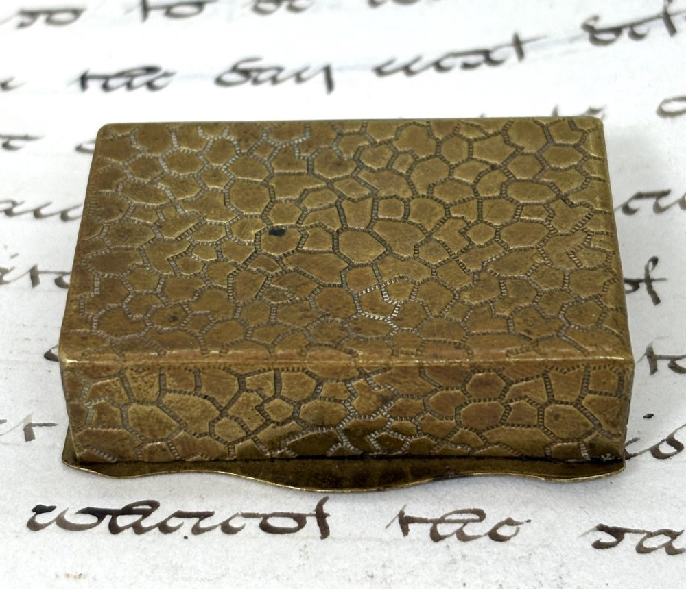 An antique French rectangular brass vesta box featuring an enamelled top panel depicting a lady and a fisherman with French text. View III