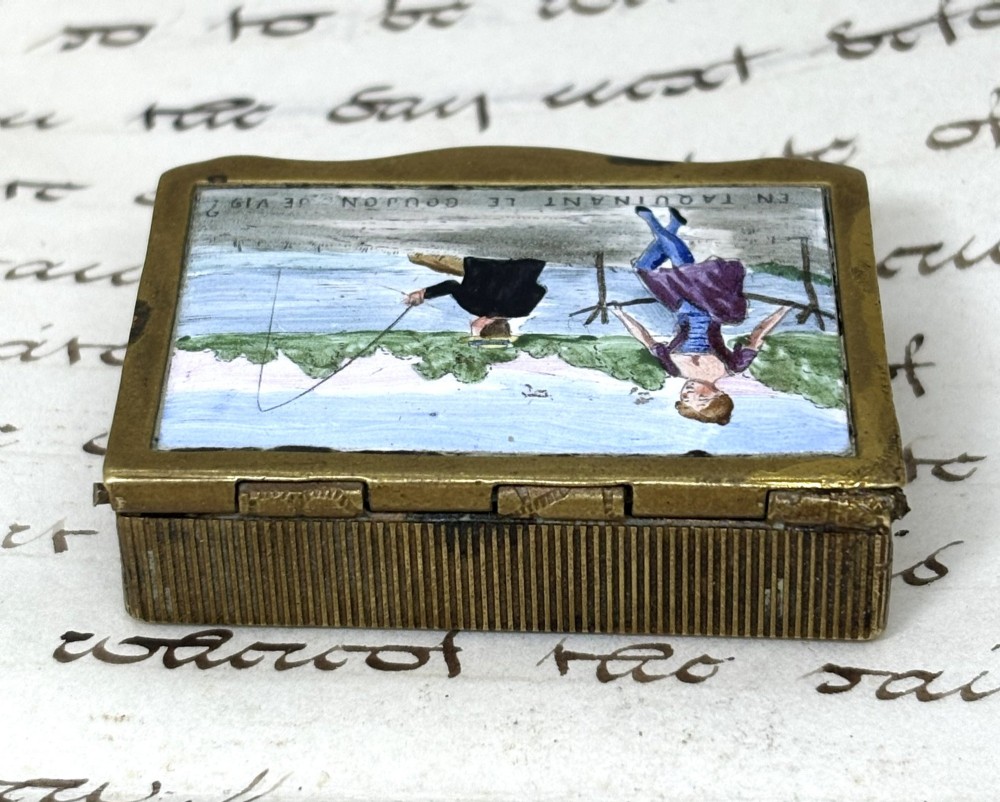 An antique French rectangular brass vesta box featuring an enamelled top panel depicting a lady and a fisherman with French text. View IV
