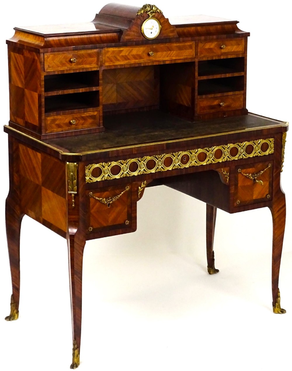 A French 19th-century kingwood writing desk with gilt-bronze ormolu mounts, upper pigeonholes and drawers, a central clock, and cabriole legs. View III