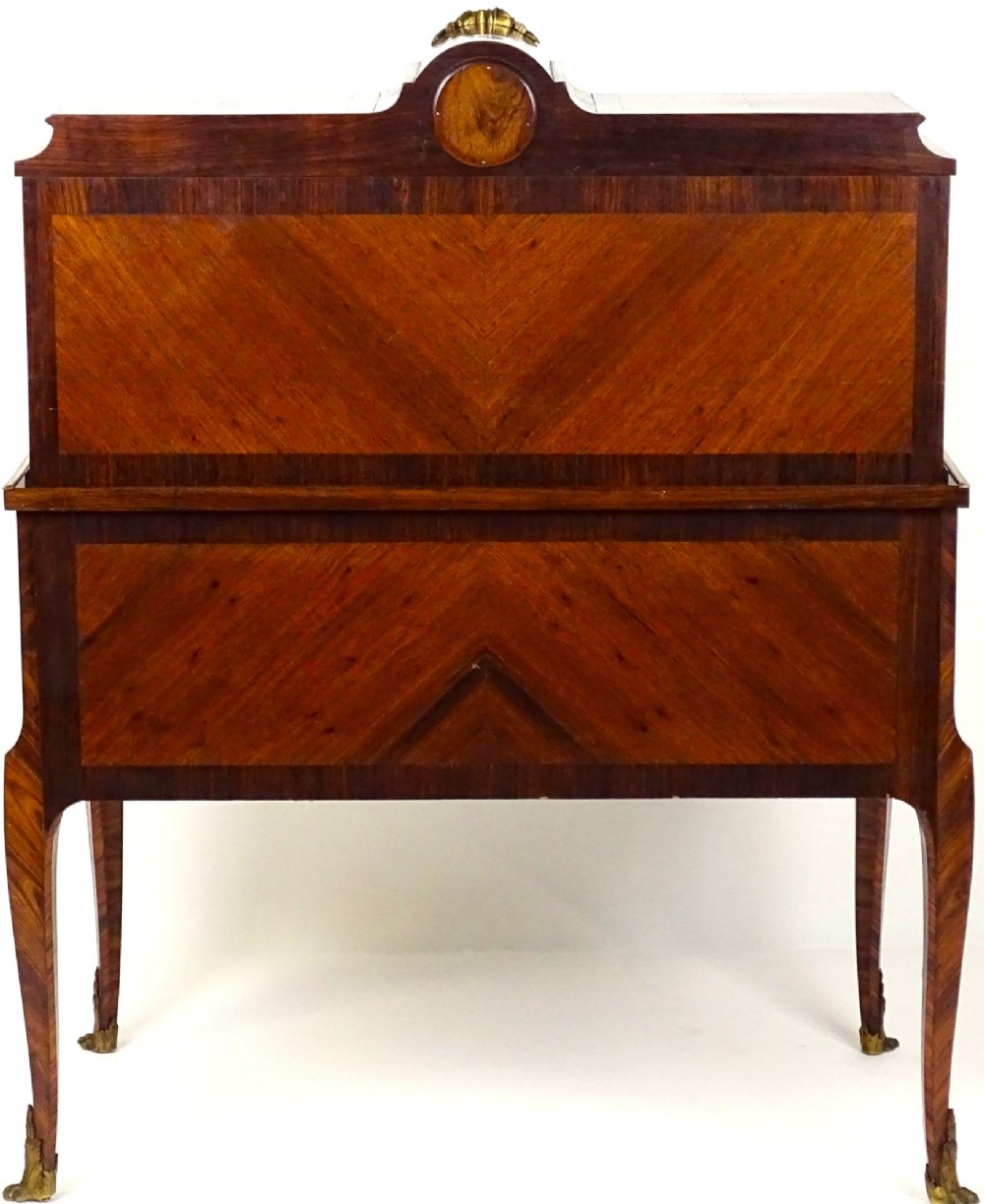 A French 19th-century kingwood writing desk with gilt-bronze ormolu mounts, upper pigeonholes and drawers, a central clock, and cabriole legs. View XV