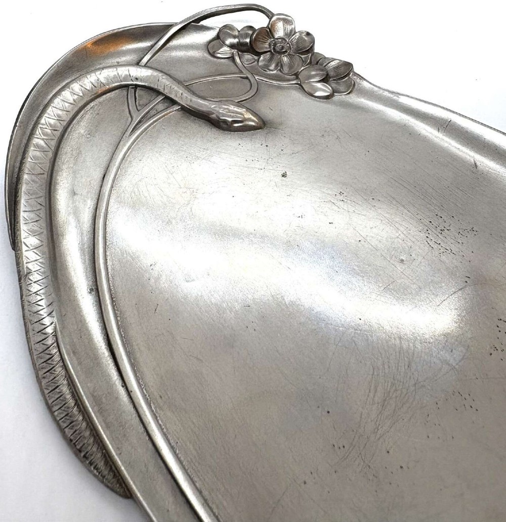 An elongated Art Nouveau silvered pewter card tray featuring a cast figure of a maiden at one end and a serpent coiling around organic leaf detail. View III