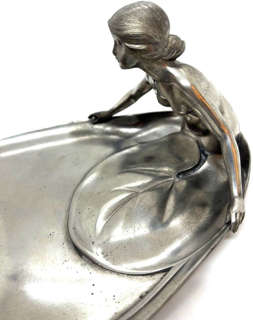 An elongated Art Nouveau silvered pewter card tray featuring a cast figure of a maiden at one end and a serpent coiling around organic leaf detail. View IV
