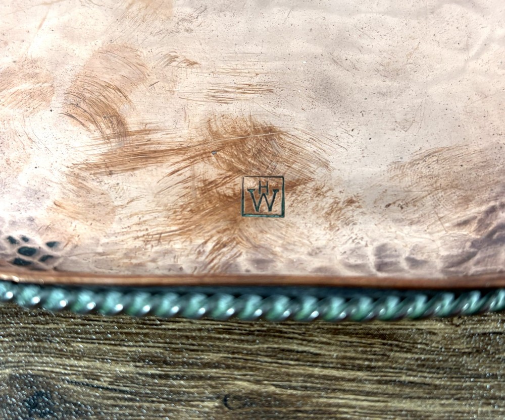 A rectangular hand-hammered copper tray featuring a central engraved floral bouquet motif, a rope-twist pewter rim, and a stamped makers mark signature. View III