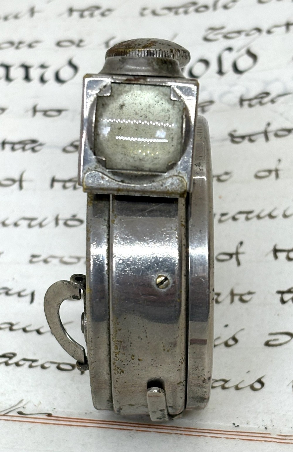 A nickel-plated Edwardian Ticka spy camera designed in the form of a pocket watch with a top-mounted viewfinder and engraved casing. View IV