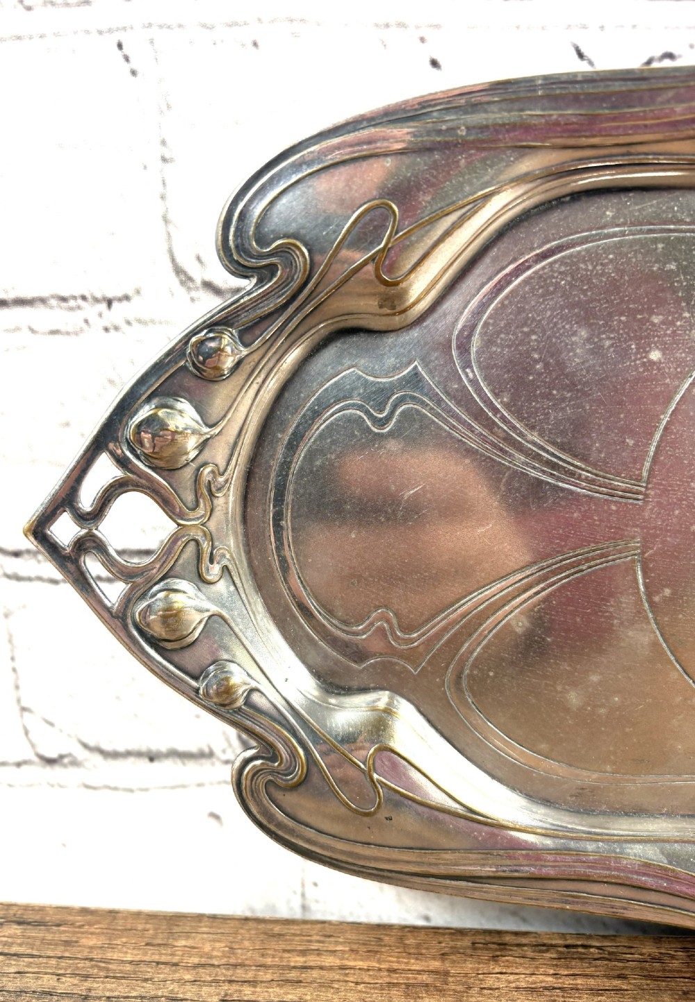 An antique rectangular silver-plated card tray featuring openwork Art Nouveau whiplash handles and engraved linear motifs in the centre. View II