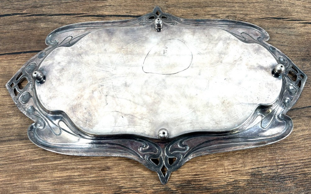 An antique rectangular silver-plated card tray featuring openwork Art Nouveau whiplash handles and engraved linear motifs in the centre. View V
