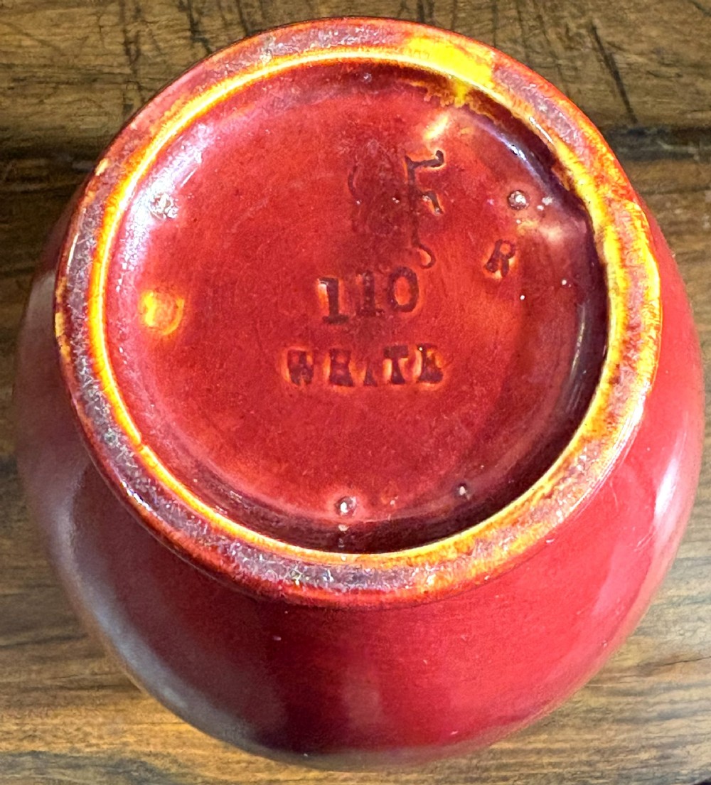 A red glazed ceramic baluster vase with a high-gloss finish. View III