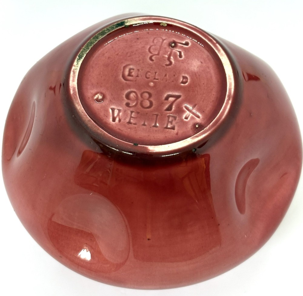 A small squat dusky pink glazed ceramic vase with a lobed rim and bulbous body. View IV