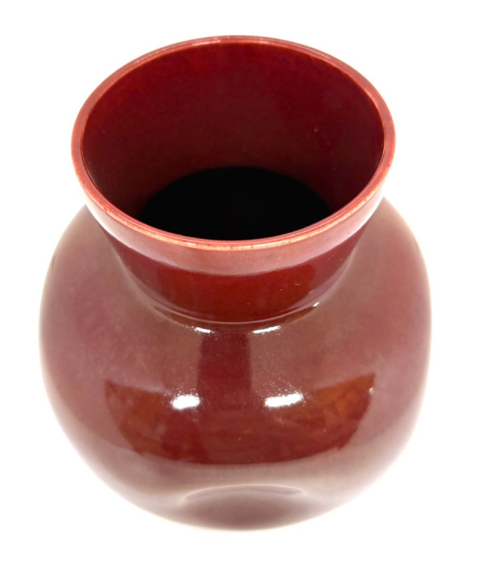 A bulbous ceramic vase with a glossy deep burgundy-brown glaze, indented dimples on the sides, and a short flared neck. View III