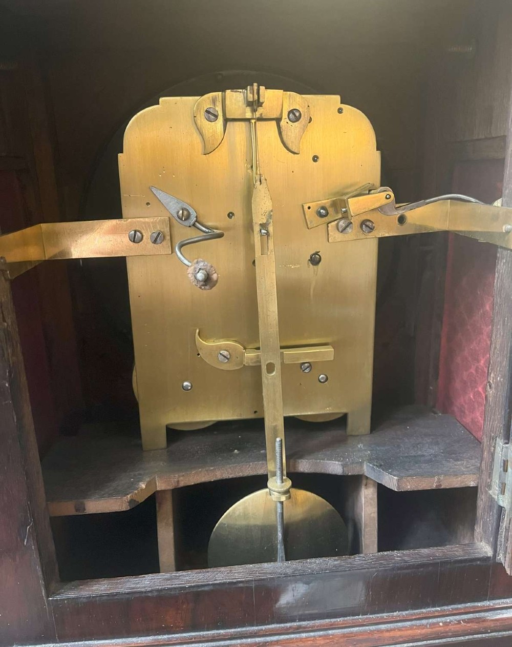 A Regency mahogany bracket clock featuring brass corner inlay, a top pineapple finial, brass ball feet, and a cream painted dial signed P. Ketterer Stamford Hill. View IX