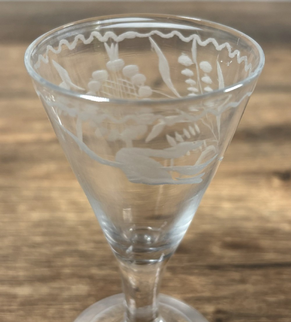 A pair of clear hand-blown Georgian glass drinking vessels featuring flared conical bowls with floral wheel engraving and circular bases. View III