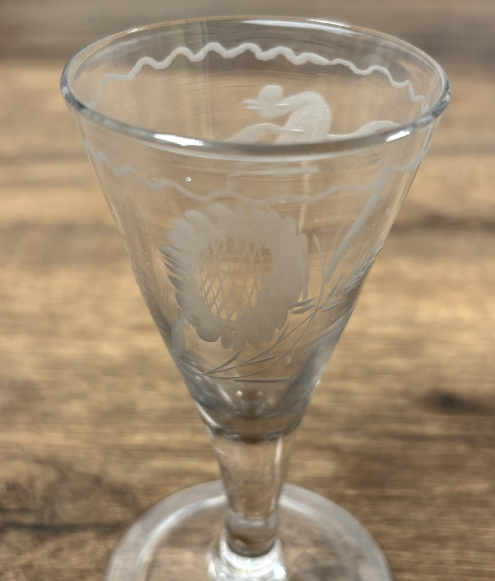 A pair of clear hand-blown Georgian glass drinking vessels featuring flared conical bowls with floral wheel engraving and circular bases. View IV