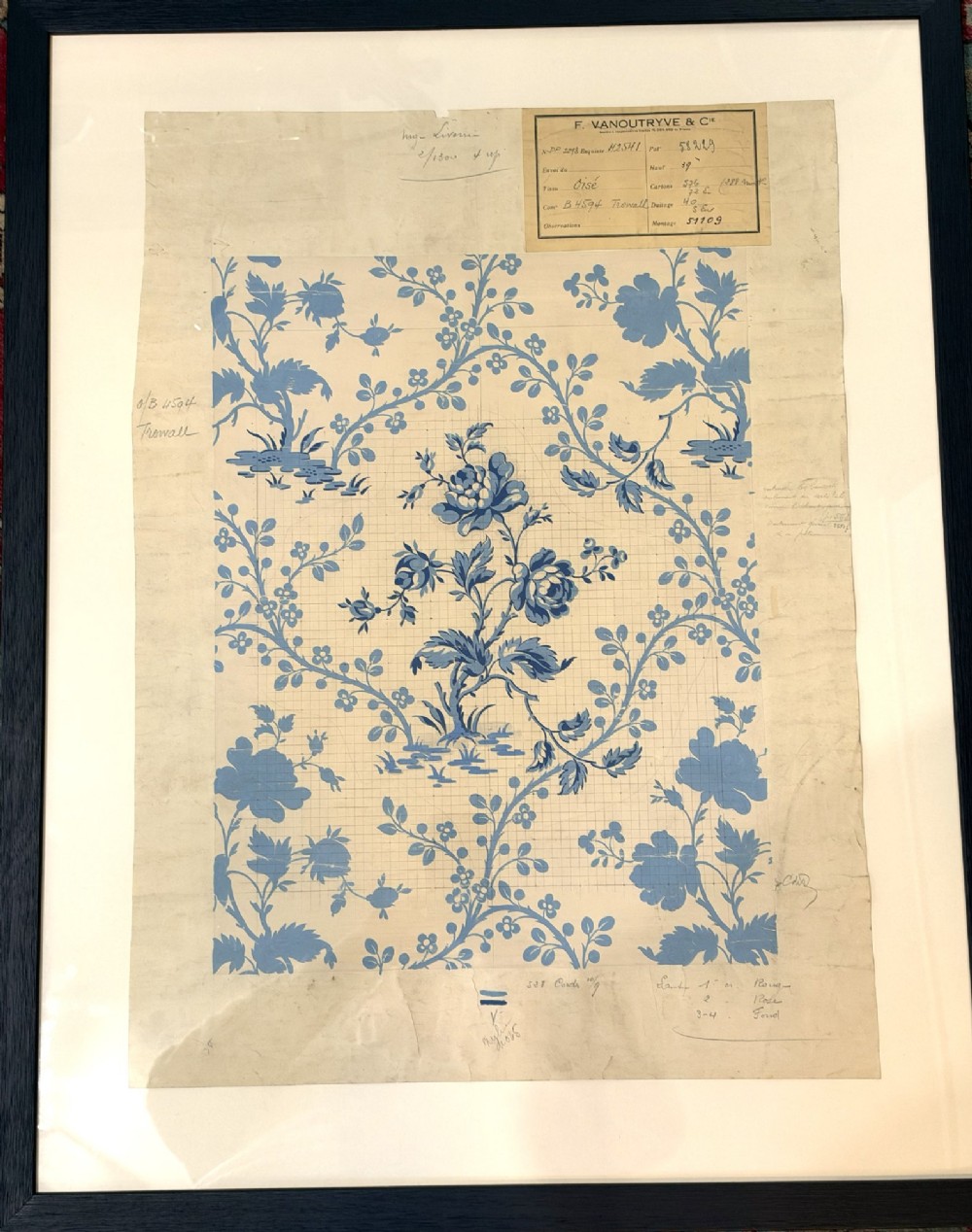 A framed vintage French textile design featuring a blue floral motif rendered on grid paper, complete with technical handwritten annotations and an original manufacturer label.