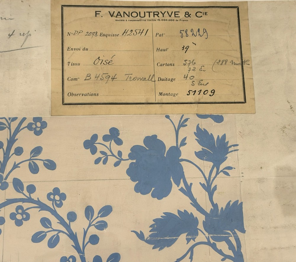A framed vintage French textile design featuring a blue floral motif rendered on grid paper, complete with technical handwritten annotations and an original manufacturer label. View III