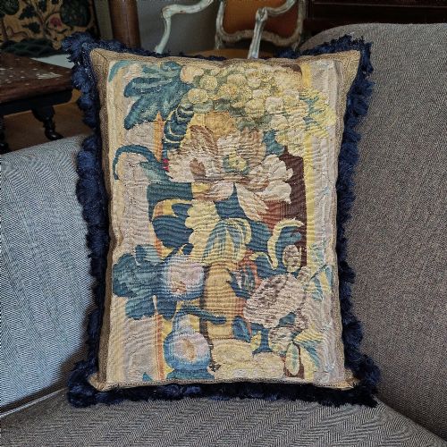 A CUSHION OF 17TH CENTURY FLEMISH TAPESTRY BORDER