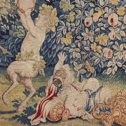 fig 1. A vertical 17th-century tapestry panel depicting figures and putti amidst dense green trees and foliage.