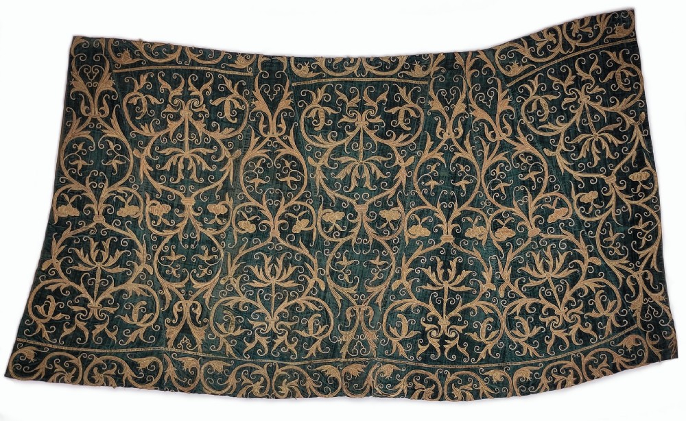 A seventeenth-century dark green silk velvet textile panel adorned with intricate gold thread embroidery featuring symmetrical arabesques and floral scrollwork.