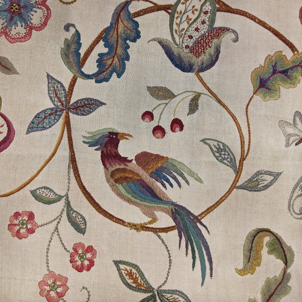 A vertical rectangular crewelwork wall hanging featuring an embroidered Tree of Life motif with scrolling vines, multicoloured flowers, birds, and a deer at the base against a cream background. View III