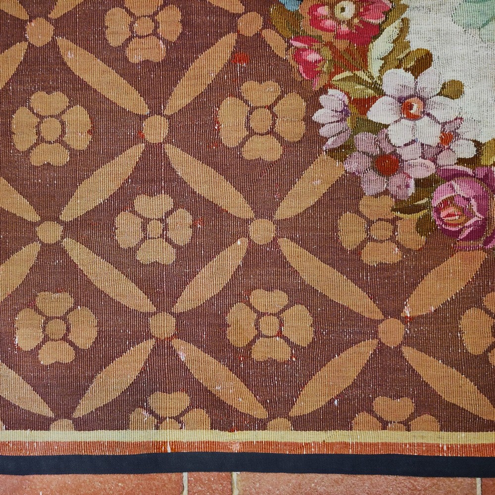 A rectangular 19th-century flatweave tapestry rug featuring a central floral medallion within a brown geometric lattice pattern. View IV
